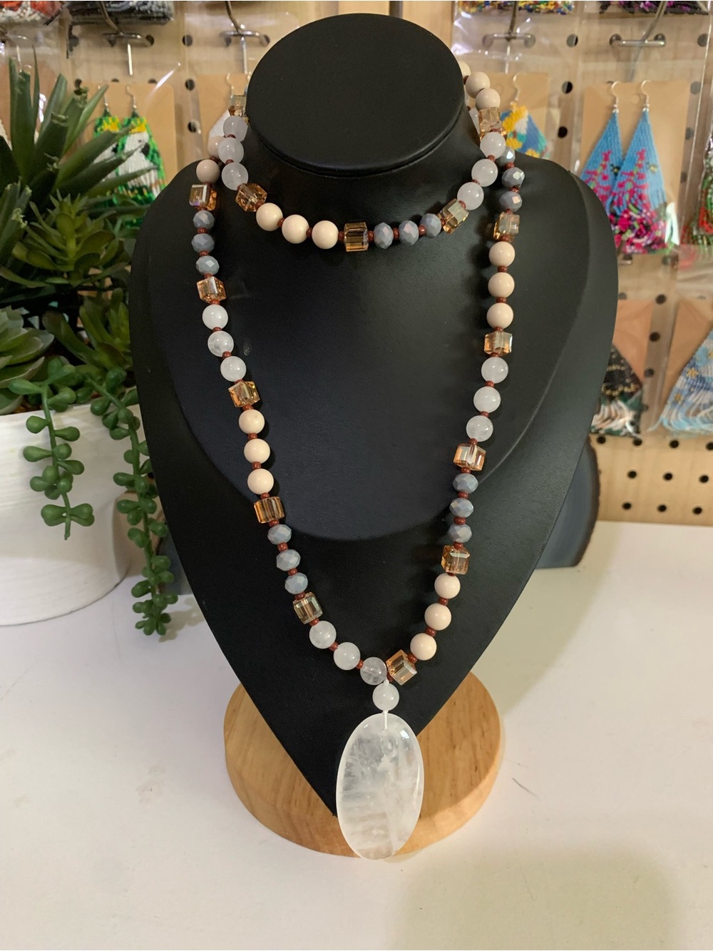 Beaded Necklace with Clear Oval Pendant in Cream and Amber Tones